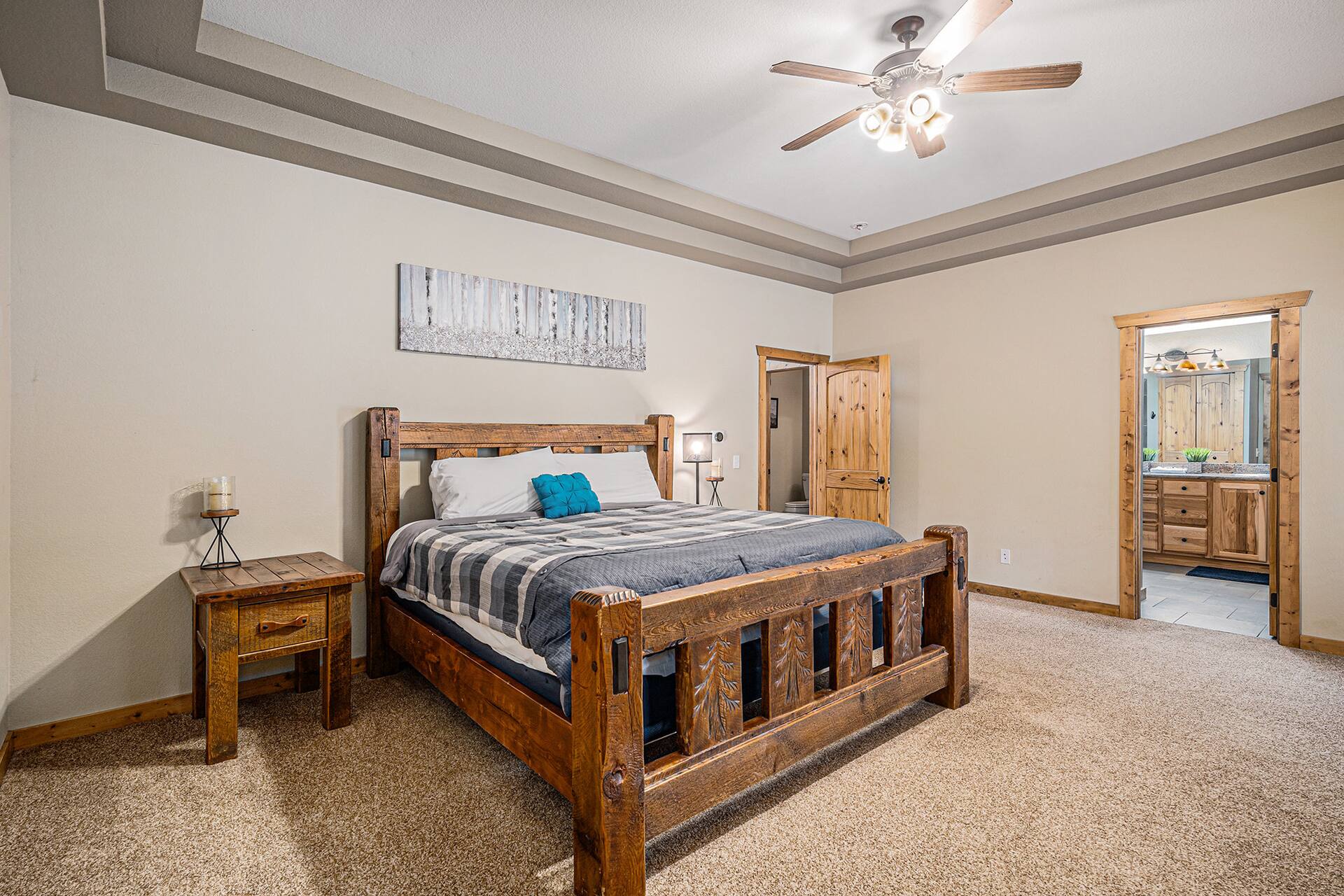Main-level primary suite with a king log bed